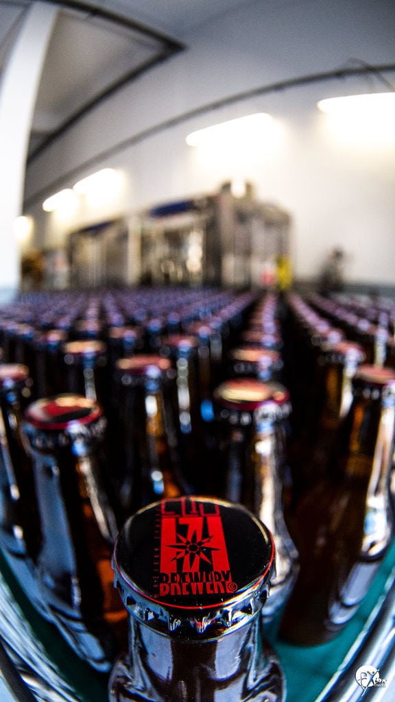 Close-up of a view of bottles at beer packaging machine at Elis Brewery plant